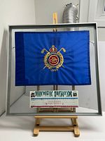 Full view of framed flag and scorecard on easel