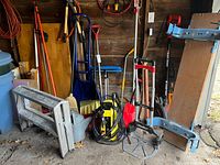 Group shot of assorted long-handle garden tools, lawn edger, pressure washer, shovels, ramps, bucket and step bench
