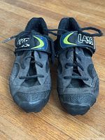 Front view of shoe pair showing uppers and strap logo