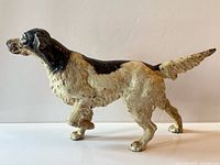 Profile view of painted cast iron English setter doorstop