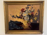 Full view of framed floral oil painting on wall