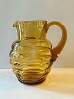 Full front view of amber glass beehive pitcher