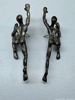 Front view pair of abstract climbing figure earrings
