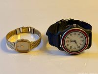 Front view of both watches showing faces, cases and straps