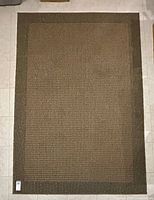 Full view of rectangular sisal-look rug on tile floor