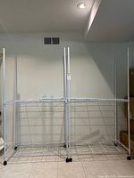 Both wire shelving units side by side on casters
