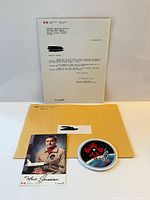 Overview showing letter, envelope, signed photo and patch