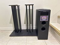 Pioneer subwoofer and two speaker stands side by side