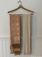 Both scarves hanging on hanger