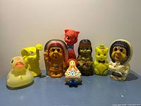 Front view of all eight plastic toys and banks