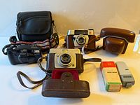 Group view showing three cameras, Zeiss flash, flashbulb boxes and camera bag