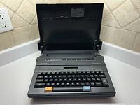 Front view of Canon Typestar 2 with cover open showing keyboard and display