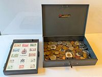 Open cash box filled with assorted Canadian coins beside Centennial stamp box