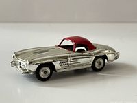 Side view of chrome Corgi Mercedes-Benz 300SL with red hardtop