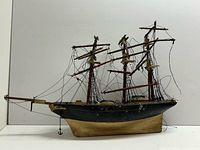 Full starboard side view of wooden frigate model with three masts and rigging
