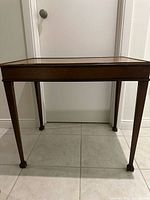 Full view of side table showing shape, legs and finish