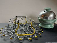 Egg cooker and folded wire basket side by side