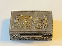 Top view of silver-plated repousse box showing lid scene and general condition