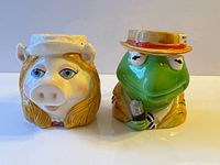 Front view of both Kermit and Miss Piggy mugs