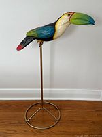 Full view of papier mache toucan on brass stand