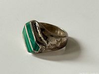 Oblique view showing malachite inlay and band tarnish