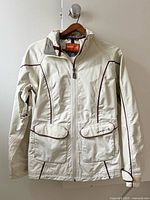 Front view of cream Merrell ski jacket with burgundy piping