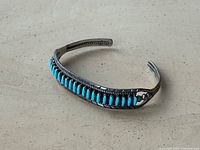 Top view of sterling cuff showing turquoise stones