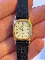 Close view of Omega De Ville watch face, strap and case