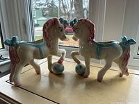 Front view of both ceramic circus horse planters