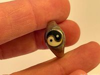 Close-up of yin-yang face on sterling silver ring