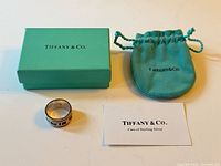 Ring, Tiffany & Co. box, pouch, and care card displayed