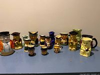 Front view of all 17 Toby mugs lined up