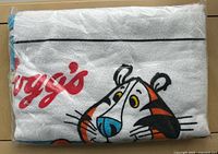Sealed towel showing Tony the Tiger face through clear plastic