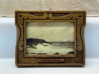 Front view of miniature framed watercolour showing carved frame and Cape Breton Scene label