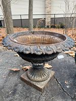 Overall view of cast iron pedestal urn planter showing bowl, rim and base