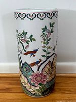 Full view of ceramic umbrella stand showing bird and floral design