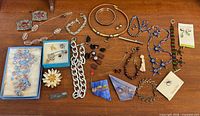 Full lot overview on wooden surface showing all jewelry pieces