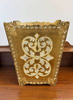 front view of gold and cream Florentine wood wastebasket