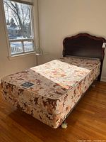 Full view of headboard, mattress, box spring and metal frame
