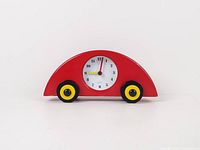 Front view of red wooden car clock showing dial and wheels