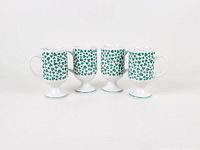 front view of four matching shamrock mugs