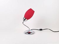 Side view of chrome base lamp with red glass shade