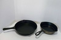 Top view of both cast iron skillets showing size difference and handles