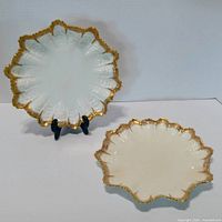 Two Coalport scalloped plates front view showing gold trim and relief pattern