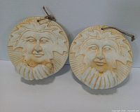 Front view of both plaques showing Leaf Man design