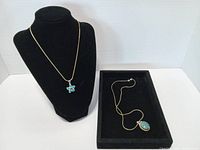 Full view of both sterling silver necklaces with pendants