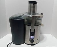 Front view of Breville BJE510XL juicer showing control panel, locking arm, pulp container and power cord