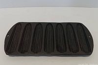 Top view showing seven corn-shaped cavities and hanging holes