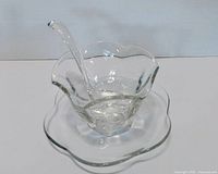 Set assembled: bowl seated on underplate with ladle inside