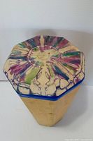 Overall view of drum showing multicolor top and hexagonal shape